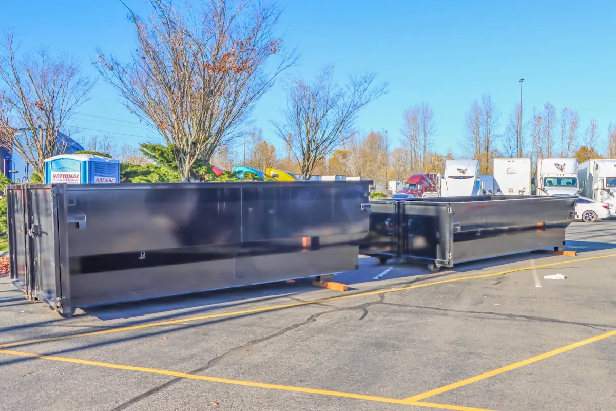 Professional dumpster rental service with roll-off container on residential driveway in Fort Smith